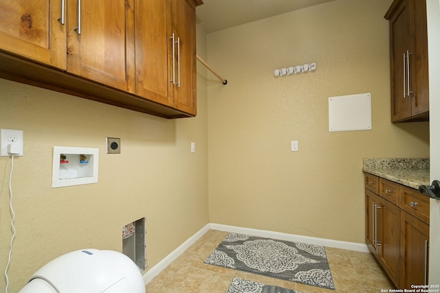 washroom featuring hookup for a washing machine, cabinet space, baseboards, and hookup for an electric dryer