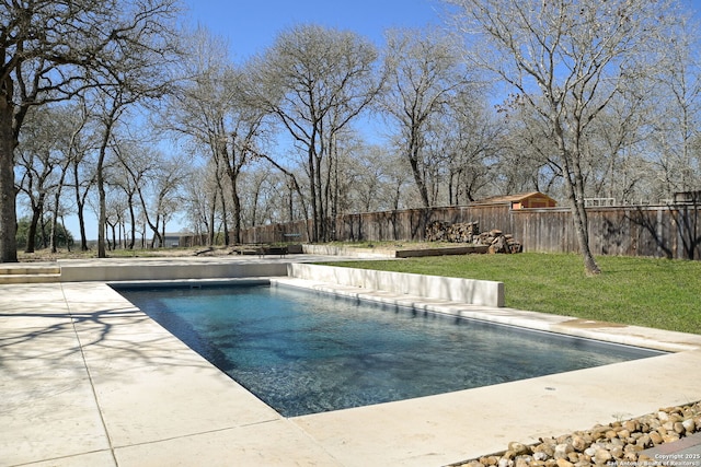 view of pool featuring a fenced in pool, a lawn, a fenced backyard, and a patio area