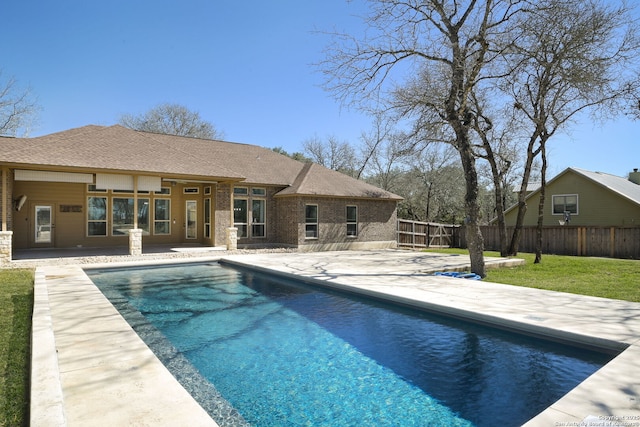 view of pool with a fenced in pool, a lawn, a patio, and fence