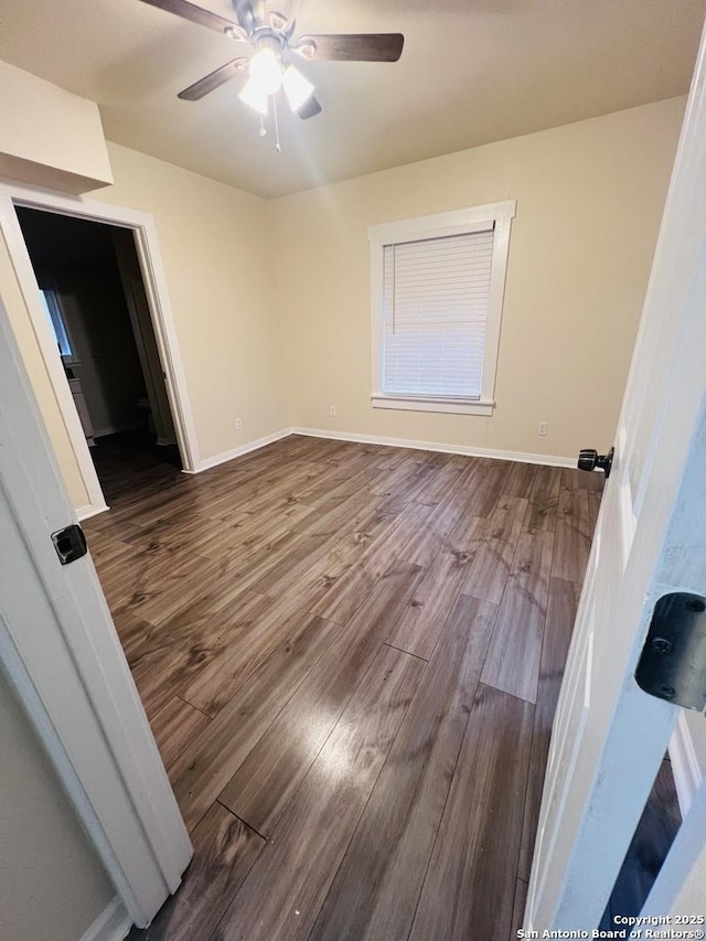 bedroom with ceiling fan, baseboards, and wood finished floors