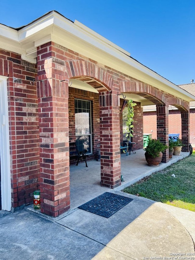 exterior space with a patio area and brick siding