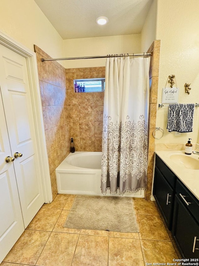 full bath featuring shower / bath combination with curtain, tile patterned flooring, vanity, and a textured ceiling