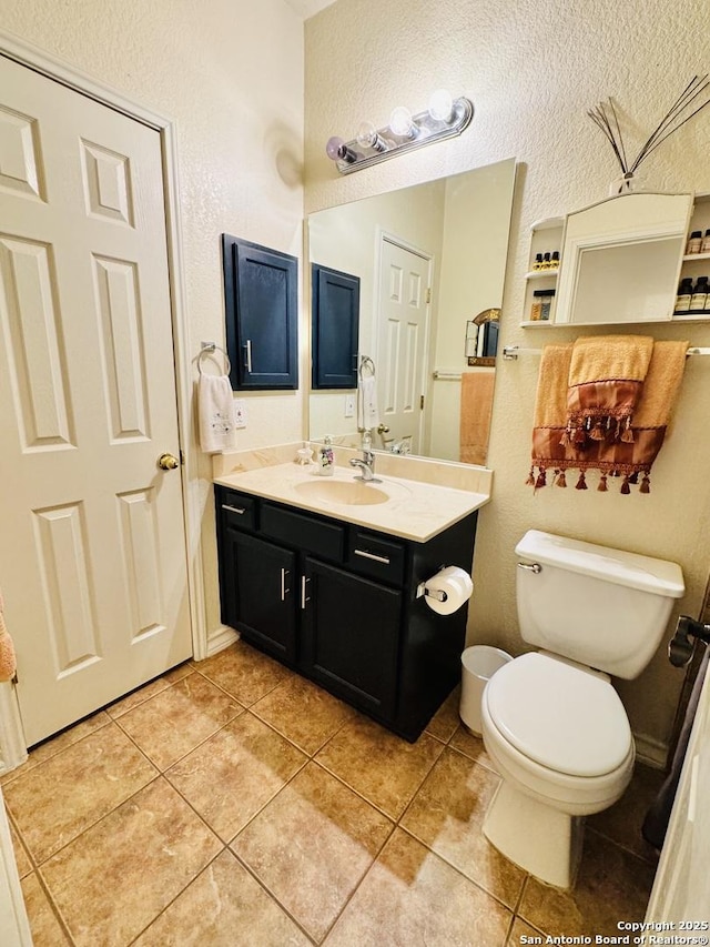 bathroom featuring vanity, toilet, and tile patterned floors