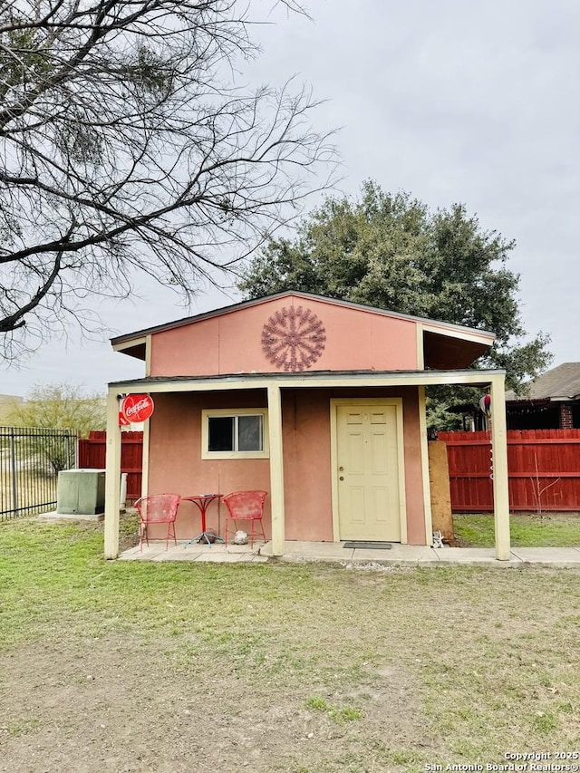 view of outbuilding featuring fence