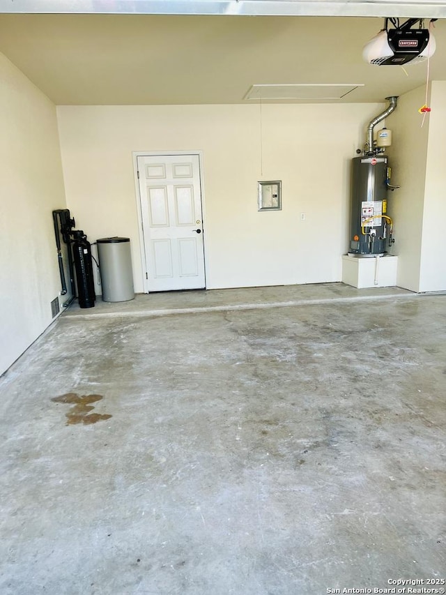 garage with a garage door opener and water heater