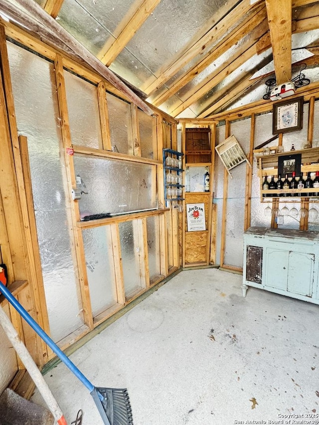 interior space with concrete floors and vaulted ceiling