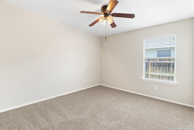 spare room featuring carpet flooring, ceiling fan, and baseboards