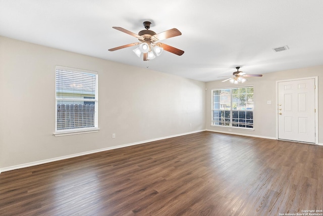 spare room with visible vents, baseboards, ceiling fan, and wood finished floors