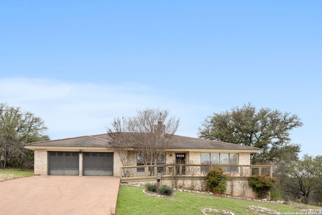 view of front of property featuring a garage, a chimney, concrete driveway, and a front yard