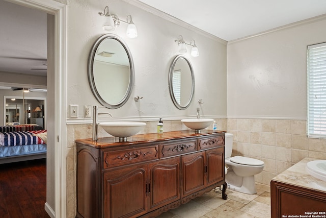 full bath featuring ornamental molding, a sink, and double vanity