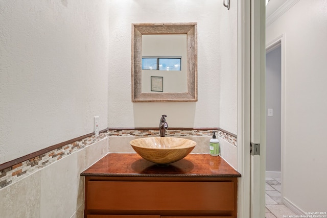 bathroom with vanity and crown molding