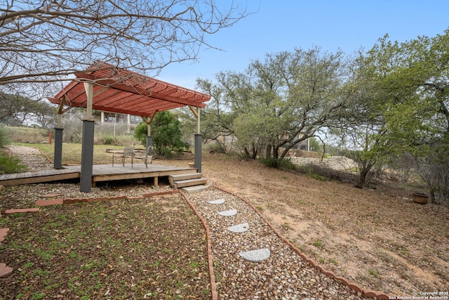 view of yard featuring a pergola and a wooden deck