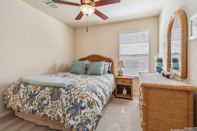 bedroom featuring light carpet, baseboards, visible vents, and a ceiling fan