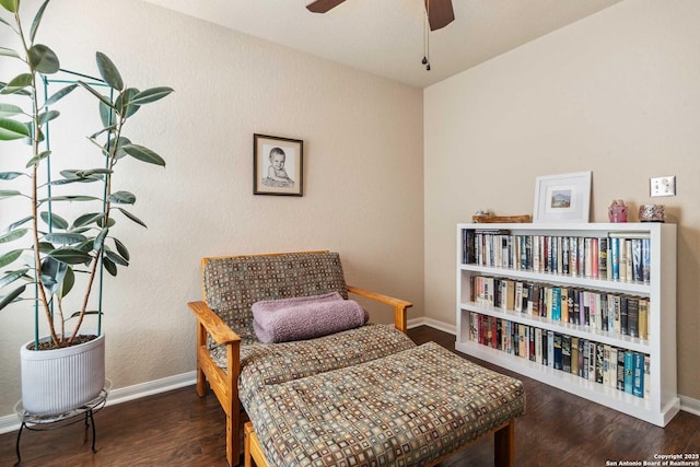 sitting room featuring ceiling fan, wood finished floors, and baseboards