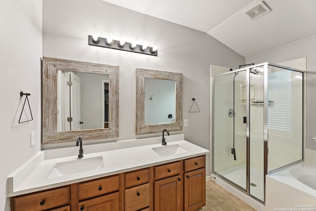 bathroom featuring tile patterned flooring, visible vents, a sink, and a shower stall