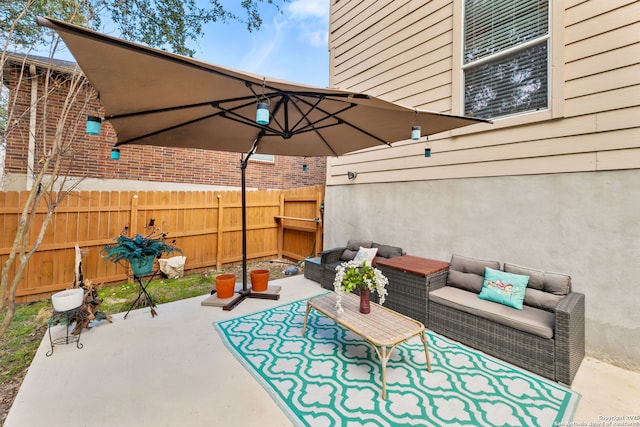 view of patio / terrace with fence and an outdoor hangout area