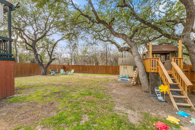 view of yard with a playground and a fenced backyard