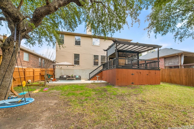 rear view of house with a yard, a patio, a chimney, a fenced backyard, and stairs