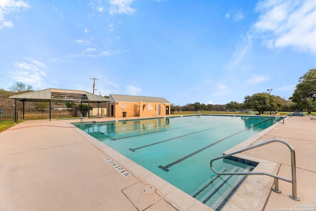 pool with a gazebo, a patio area, and fence