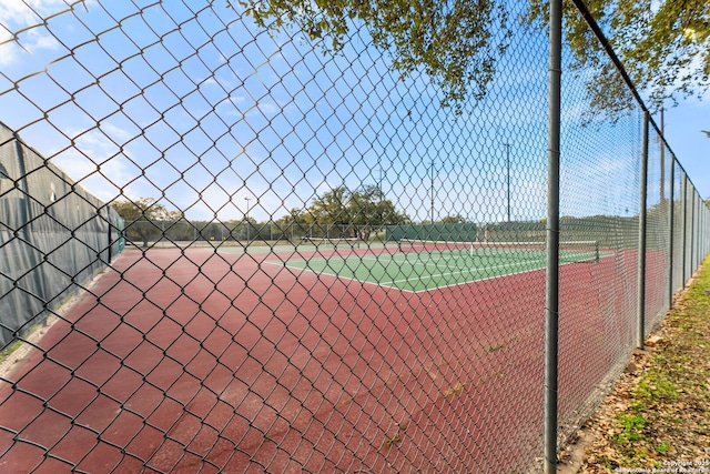 view of sport court with fence