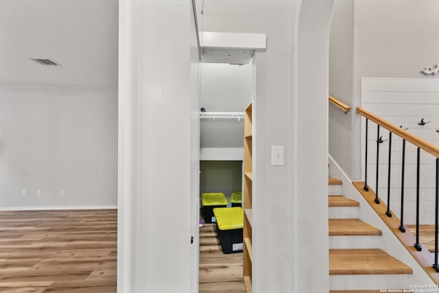 stairway featuring baseboards and wood finished floors