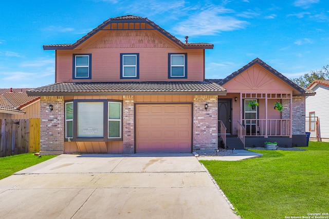 view of front of house featuring driveway, a tile roof, covered porch, fence, and a front lawn