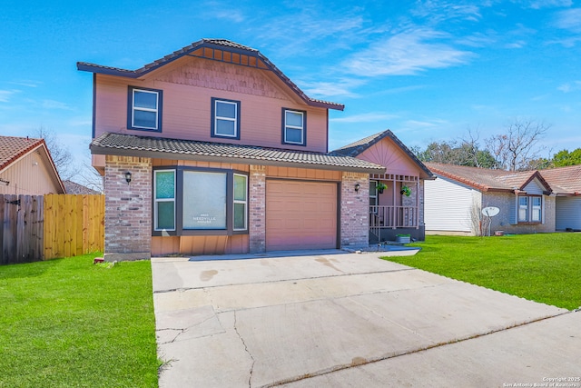 view of front facade with brick siding, concrete driveway, a front yard, fence, and a garage