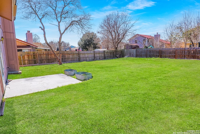 view of yard featuring a patio area and a fenced backyard