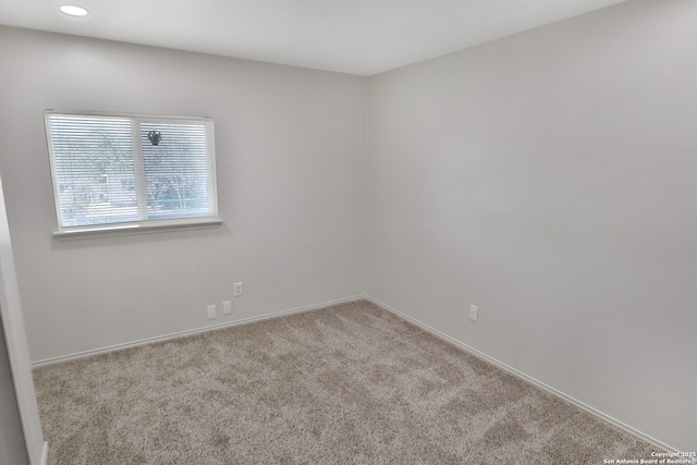 carpeted empty room featuring baseboards and recessed lighting