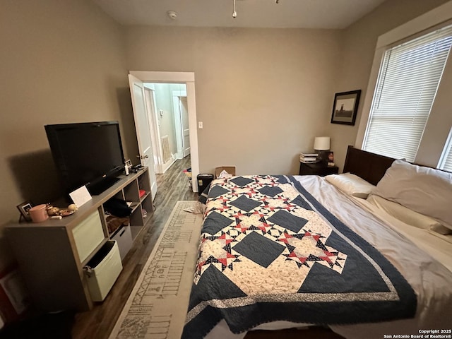 bedroom with dark wood-type flooring