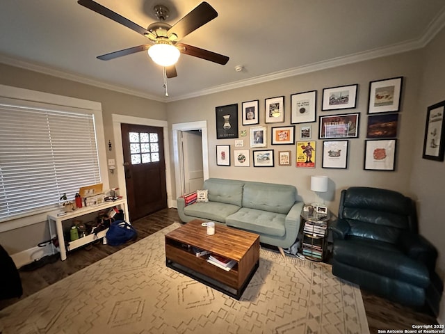 living room with ornamental molding, ceiling fan, and wood finished floors