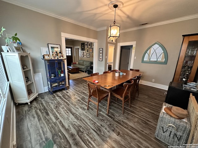 dining space with crown molding, dark wood finished floors, visible vents, and baseboards