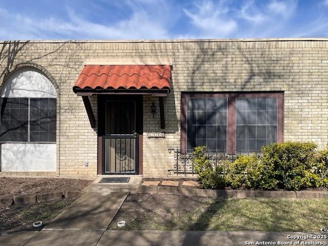 property entrance with brick siding