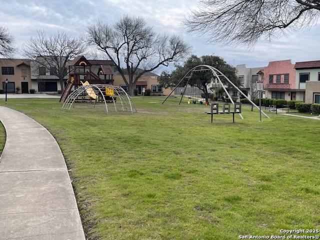 community playground with a lawn and a residential view