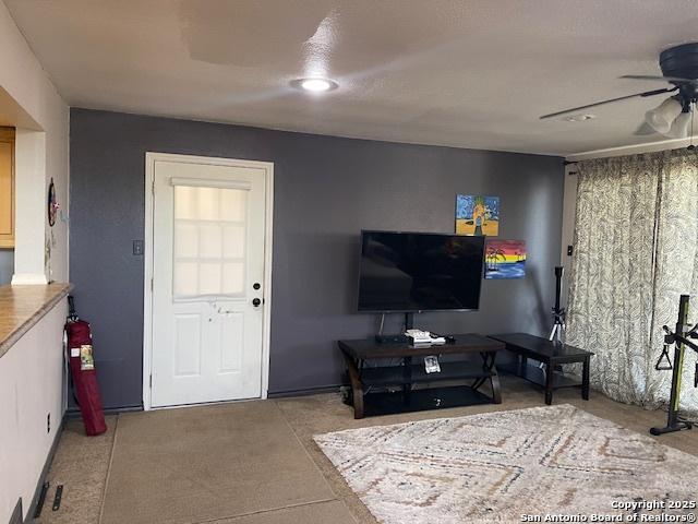 living area featuring a ceiling fan