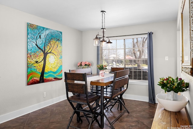 dining area featuring baseboards