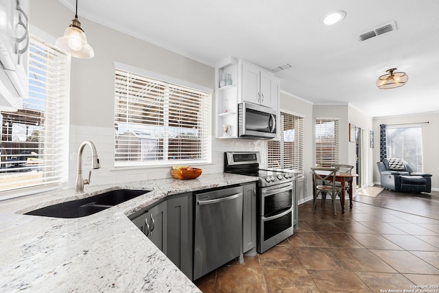 kitchen with stainless steel appliances, open shelves, a sink, and visible vents