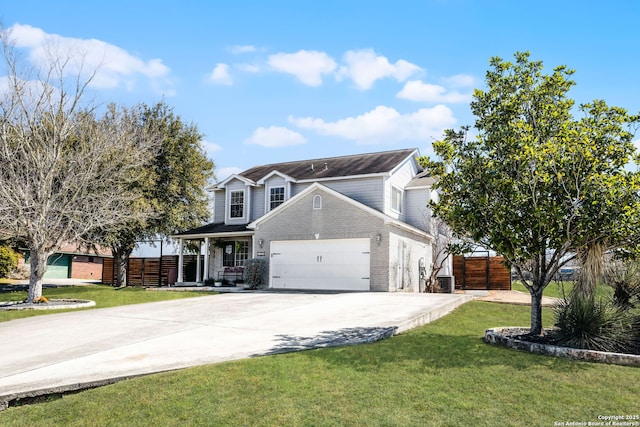 traditional-style house with driveway, an attached garage, fence, and a front yard