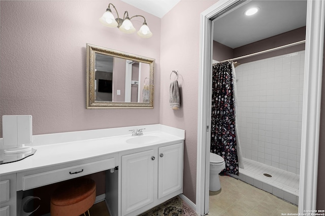 bathroom featuring a textured wall, vanity, a shower stall, and toilet