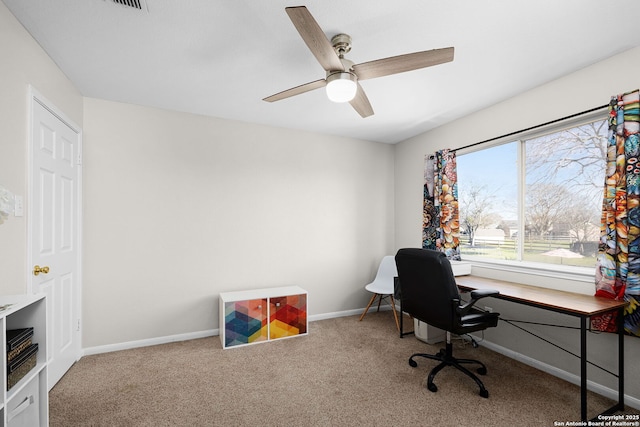 carpeted office with a ceiling fan and baseboards