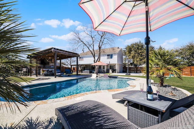 outdoor pool with a patio area and a fenced backyard