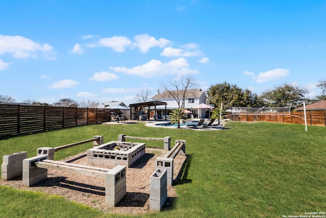 view of yard featuring a garden, fence, a patio, and a pergola