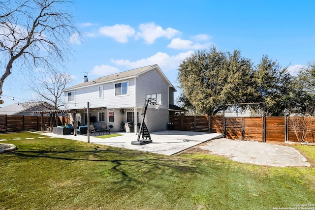 back of house with a chimney, a lawn, a gate, a patio area, and a fenced backyard