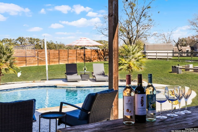 view of swimming pool featuring a fenced backyard, a fenced in pool, and a yard