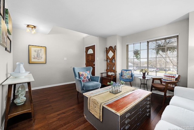 living area with baseboards and wood finished floors