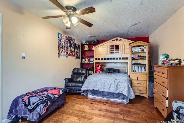 bedroom with ceiling fan, a textured ceiling, and wood finished floors