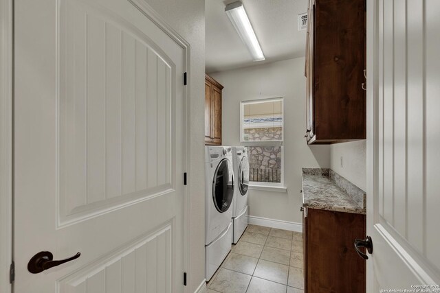 948 Hudson, New Braunfels, TX 78130 - laundry room featuring cabinet space, light tile patterned floors, visible vents, baseboards, and washer and dryer