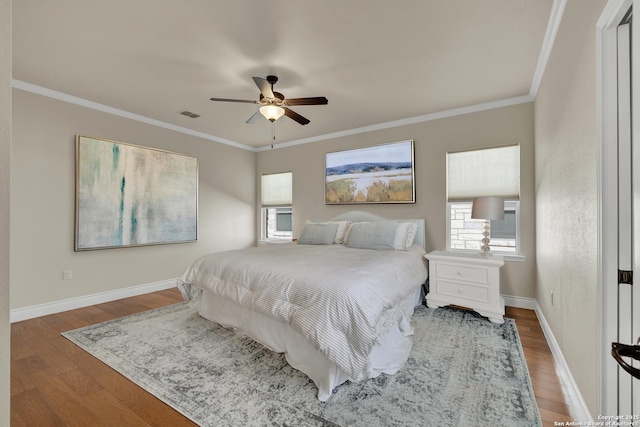 948 Hudson, New Braunfels, TX 78130 - bedroom featuring baseboards, visible vents, a ceiling fan, wood finished floors, and crown molding