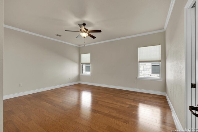 948 Hudson, New Braunfels, TX 78130 - empty room featuring wood finished floors, visible vents, and crown molding