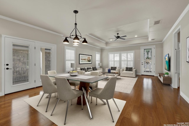 948 Hudson, New Braunfels, TX 78130 - dining area featuring a raised ceiling, ornamental molding, dark wood finished floors, and visible vents
